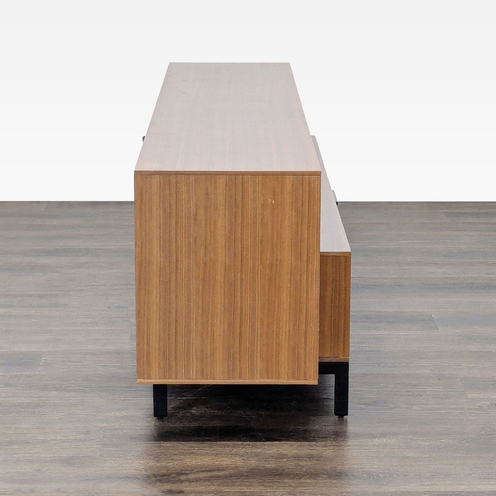 2. Sleek side profile of a BDI walnut console showing clean lines and black metal legs for a minimalist look.