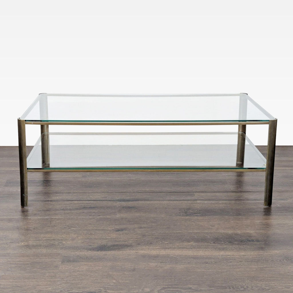2. Modern coffee table featuring clear glass surfaces and sturdy metal legs, viewed from the front.