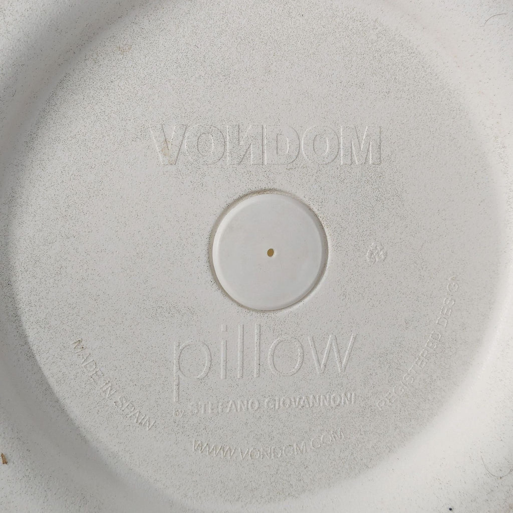 Close-up of the embossed Vondom brand and model details on the underside of the chair.