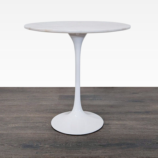 1. Modern round end table with a white marble top and sleek pedestal base on a wood floor.