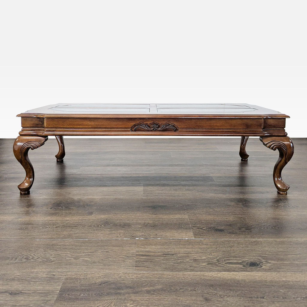 Coffee table with beveled glass top, burlwood border, and elegant cabriole legs.  