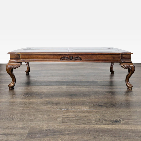 Coffee table with beveled glass top, burlwood border, and elegant cabriole legs.  