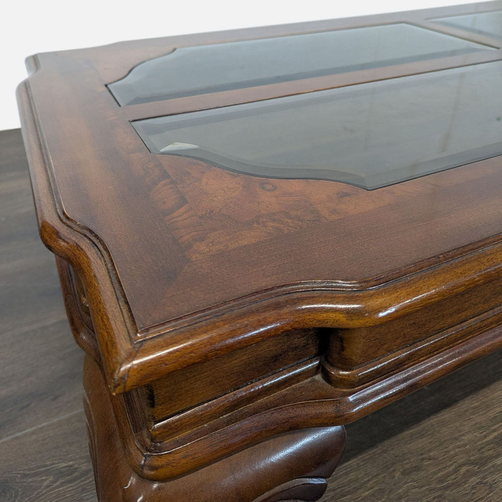 Elegant coffee table featuring beveled glass inserts, burlwood surround, and cabriole legs.  
