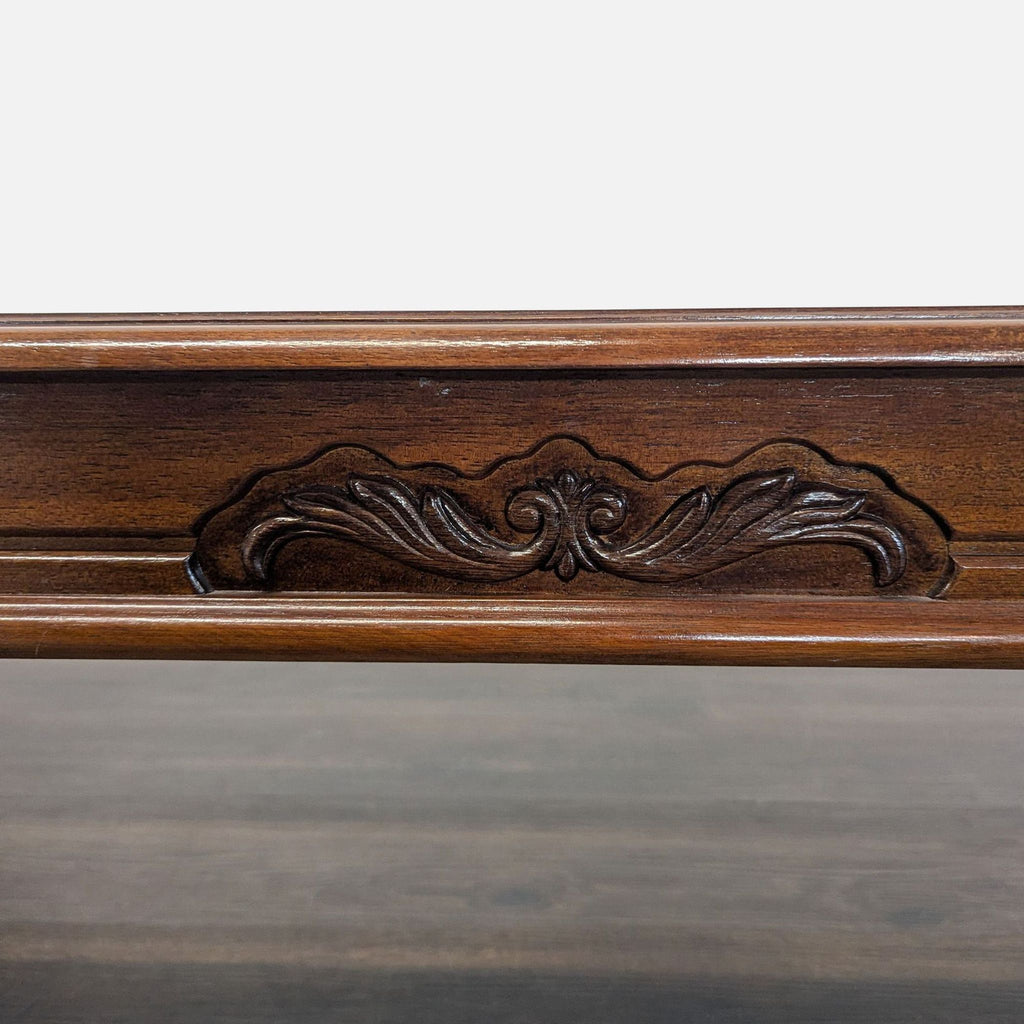 Classic coffee table with a glass-inset top, detailed burlwood trim, and curved cabriole legs.