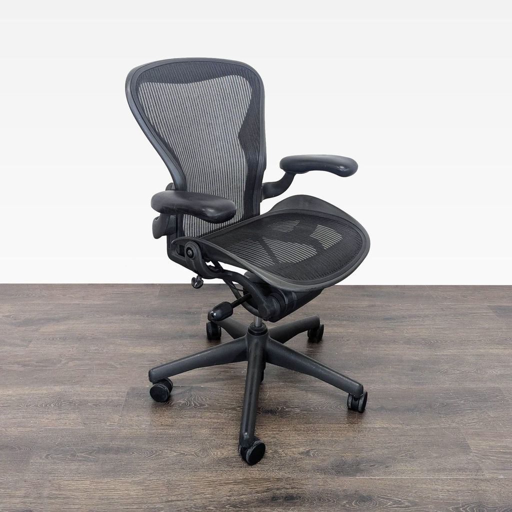 Modern Herman Miller desk chair featuring a breathable mesh design and customizable armrests for comfort.