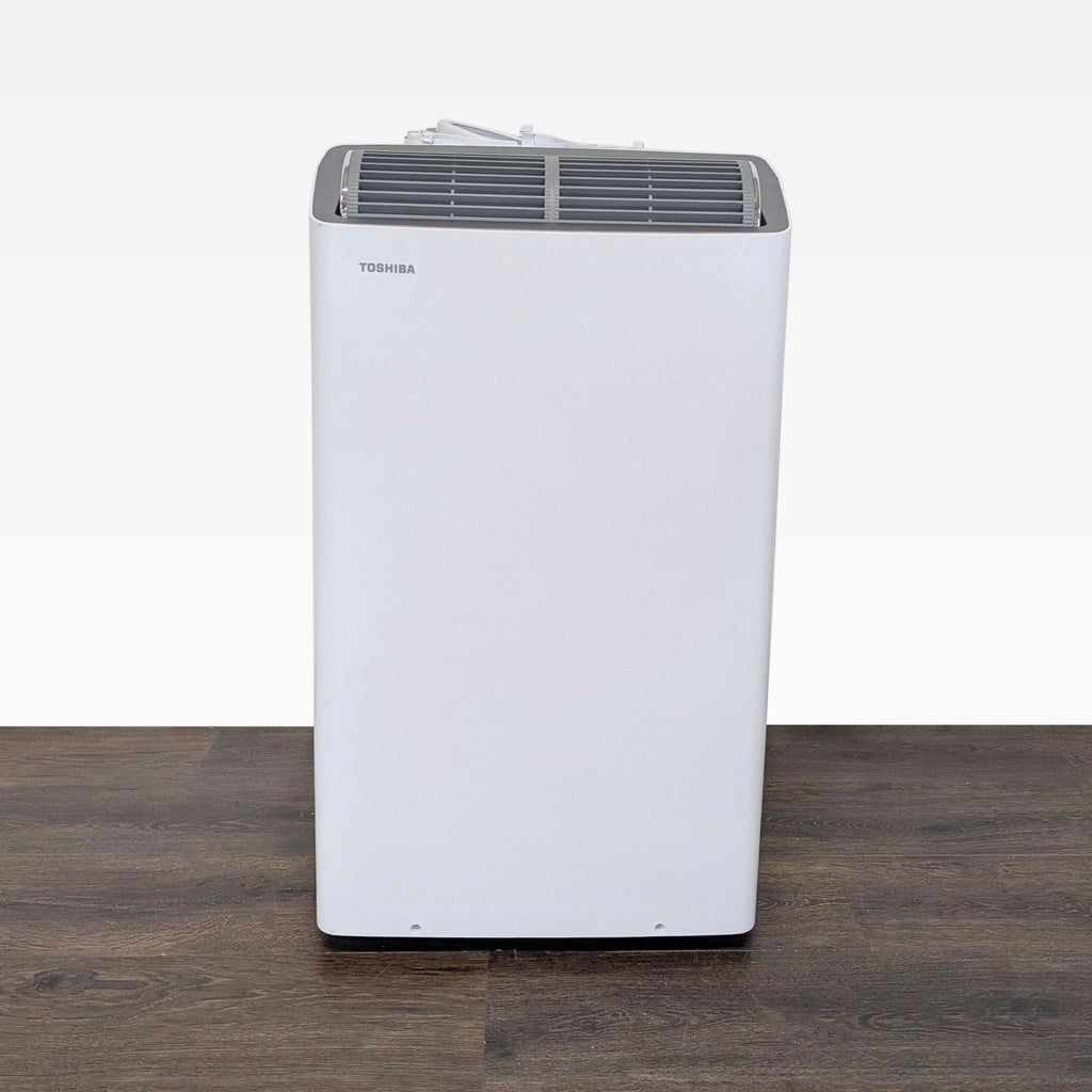 Toshiba portable air conditioner with sleek design, perfect for cooling small rooms; easy controls visible.  