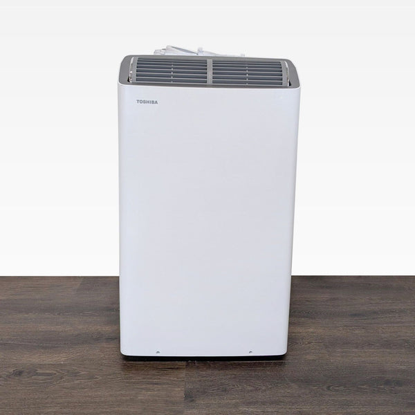 Toshiba portable air conditioner with sleek design, perfect for cooling small rooms; easy controls visible.  