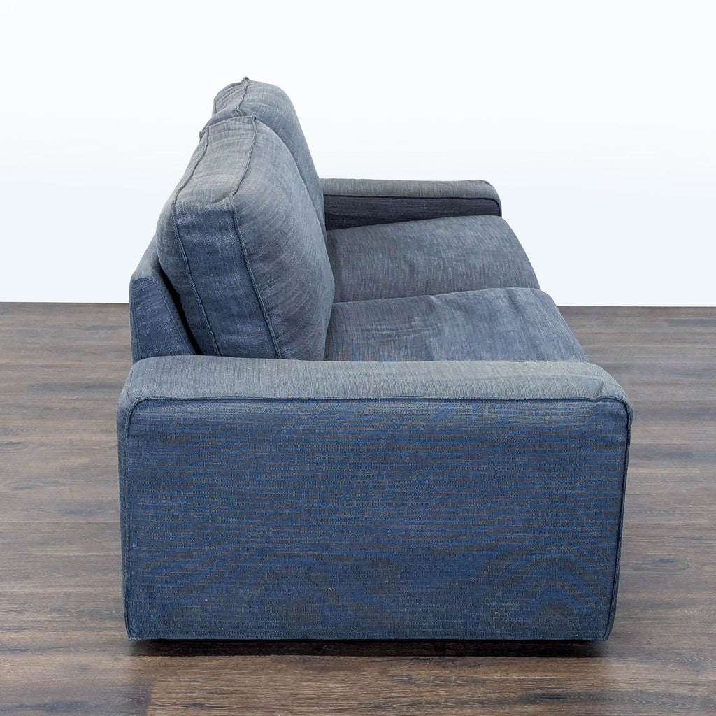 Spacious Ikea 3-seater sofa in sleek gray fabric, wide armrests, perfect for lounging or hosting guests.