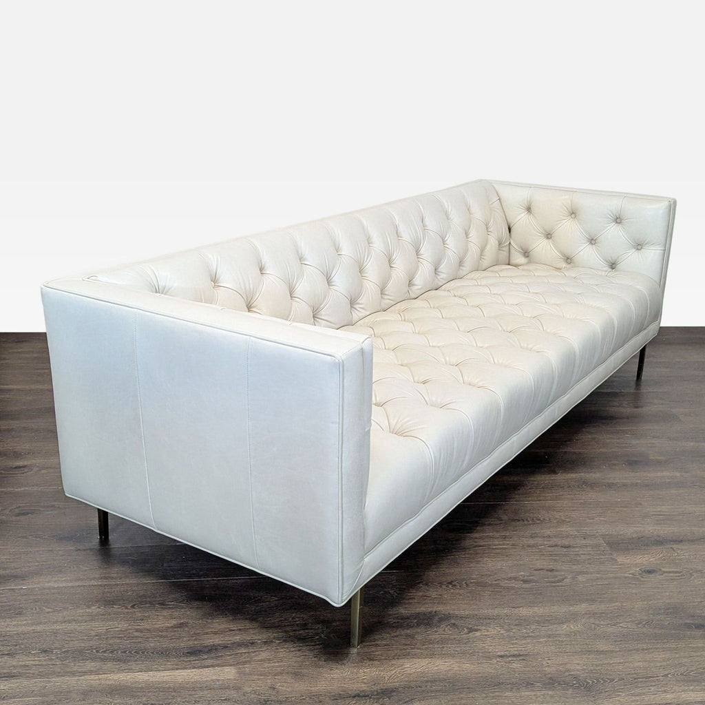 Ivory Grotto leather 3-seat sofa with high arms, boxy silhouette, and elegant tufted seat and backrest.  