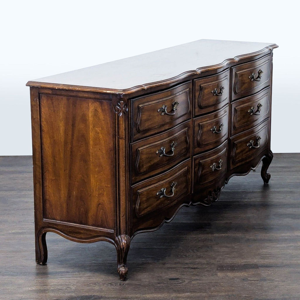 2. Drexel vintage dresser with nine drawers, elegant curved detailing, and polished dark wood finish, drawers closed.