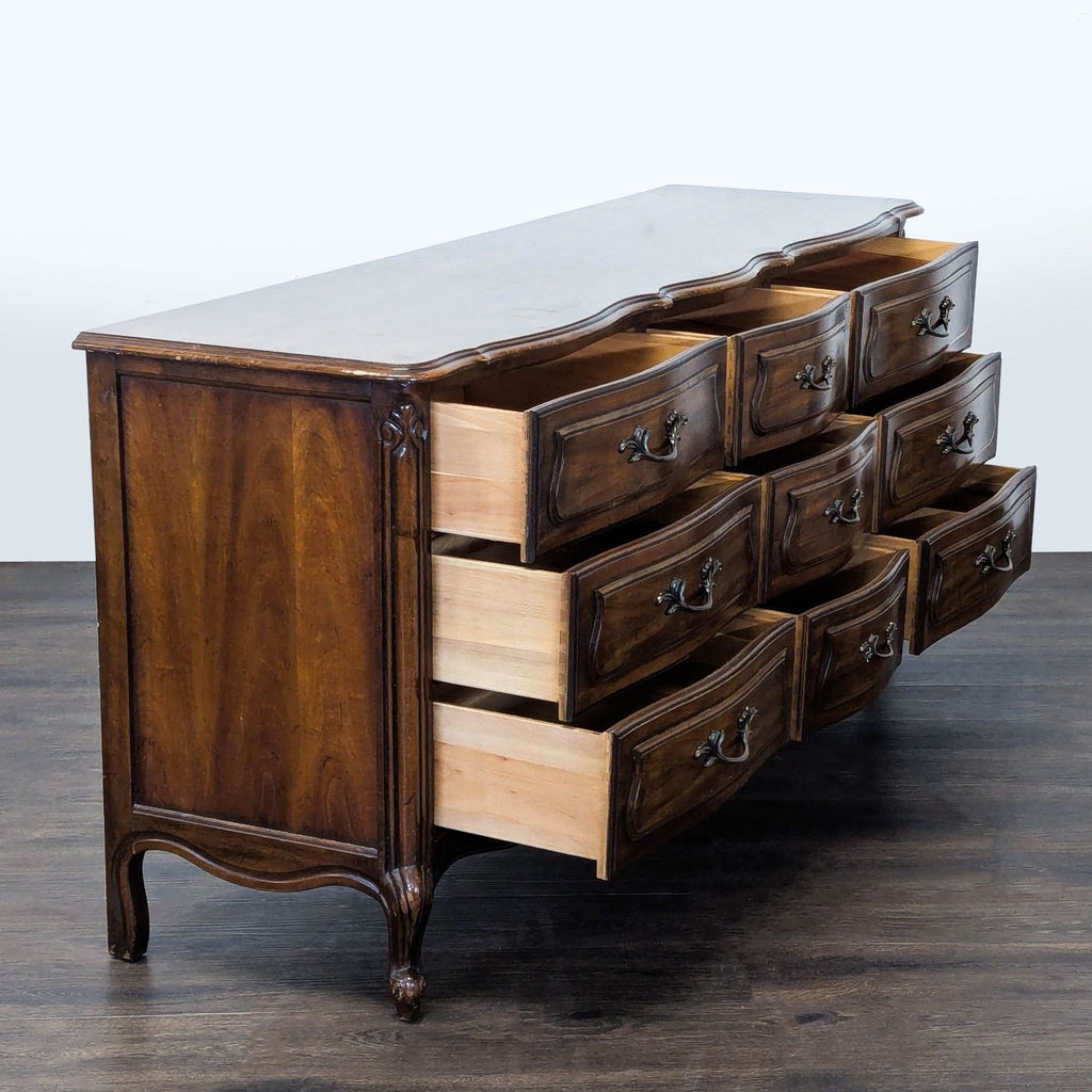 1. Drexel dresser featuring nine ornate drawers, shown open, with dark wood and curved vintage design.  