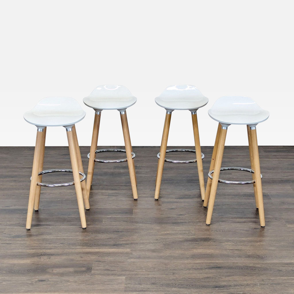 Modern white ABS stool with beechwood legs and a chrome footrest, ideal for contemporary interiors.