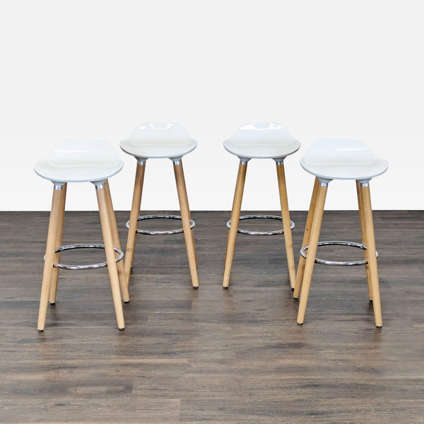 Modern white ABS stool with beechwood legs and a chrome footrest, ideal for contemporary interiors.