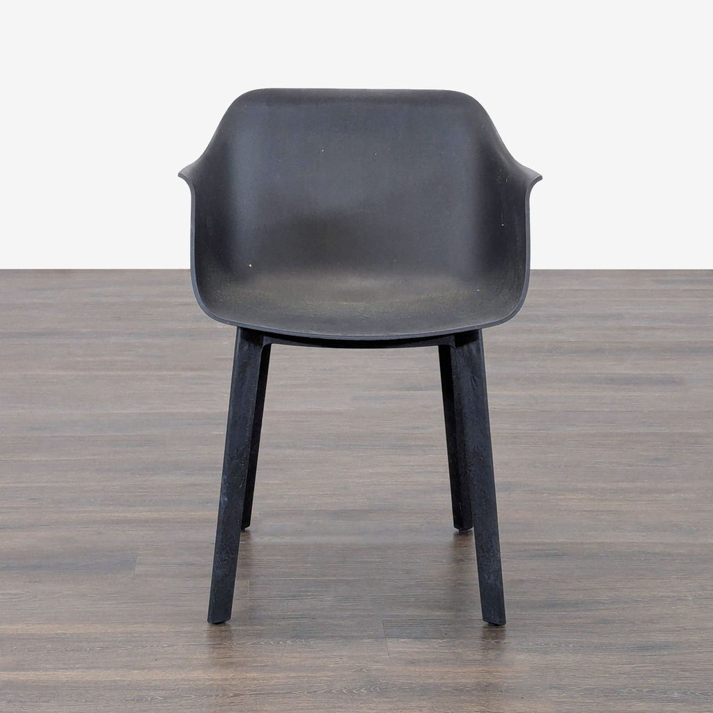 Six sturdy black plastic chairs by Resol, featuring armrests and sleek, contemporary lines.