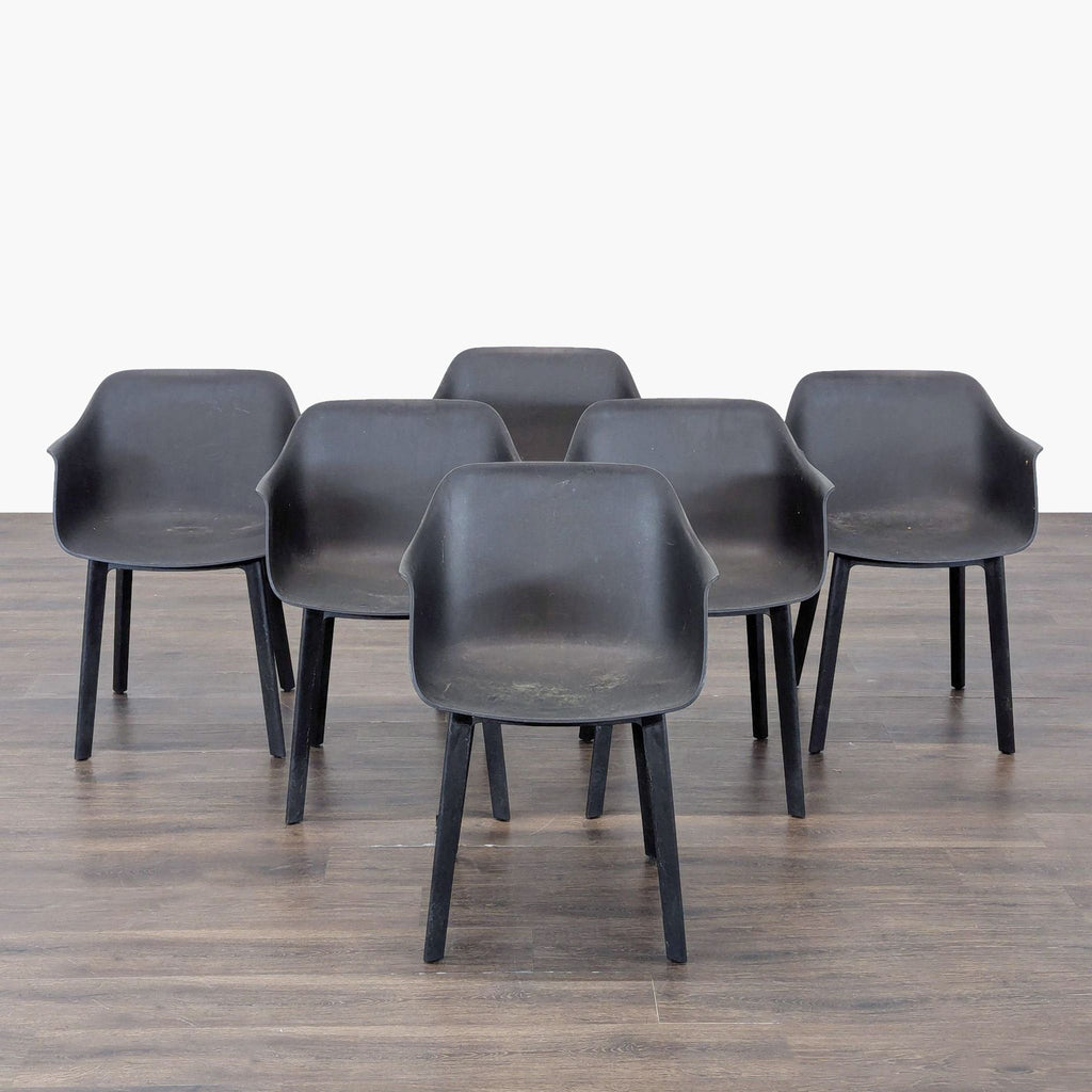 Set of six black Resol plastic chairs with armrests and a modern, minimalist design.