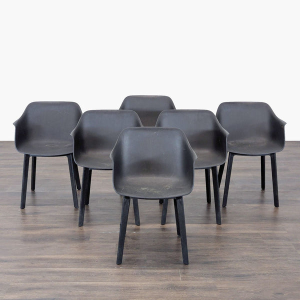 Set of six black Resol plastic chairs with armrests and a modern, minimalist design.