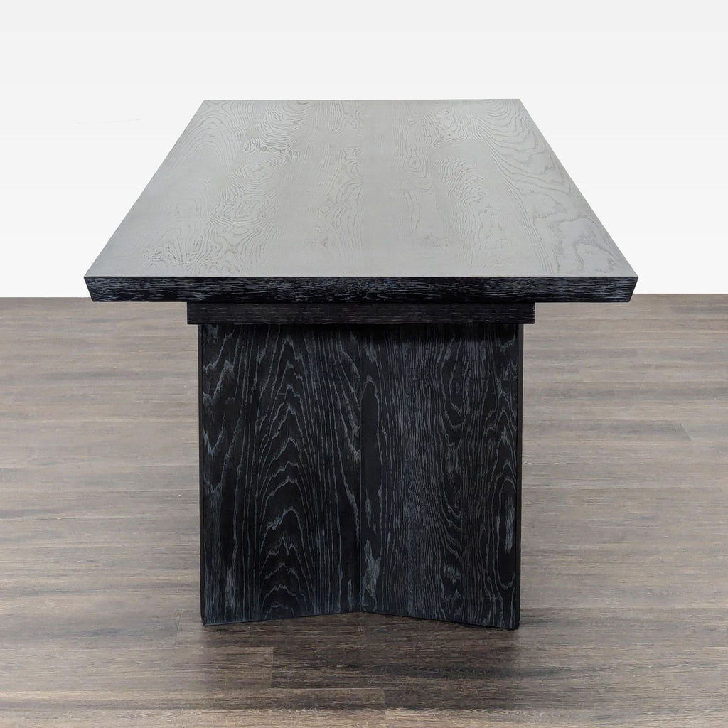 Rectangular dining table featuring rich oak grain, kiln-dried construction, and a hand-applied matte lacquer seal.