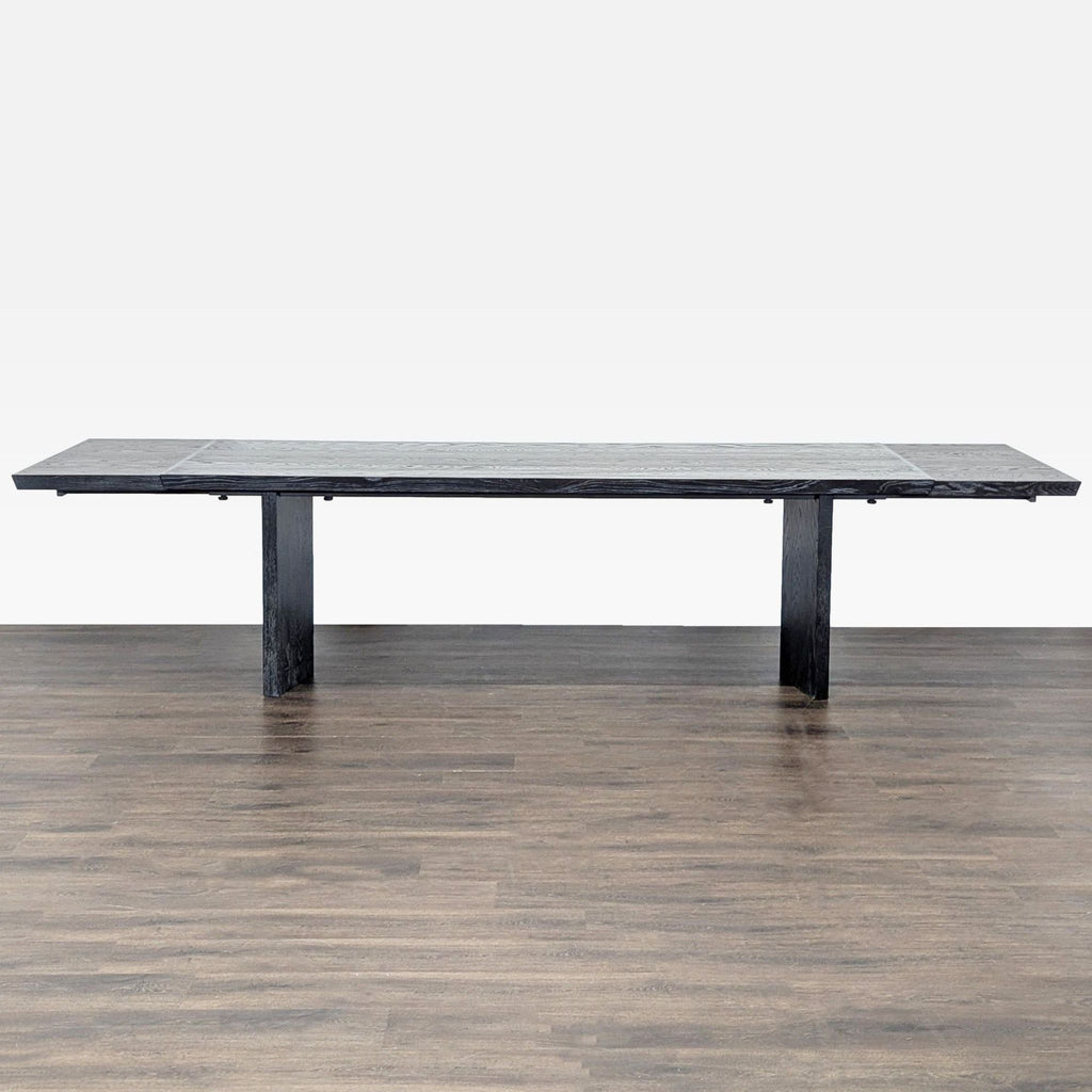 Modern oak veneer dining table with dramatic angled edges, matte finish, and two removable extension leaves.  