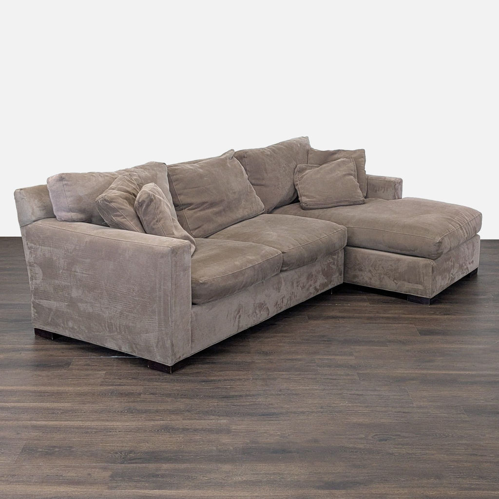 2. Angled side view of a modern Crate & Barrel sectional, showing broad seating and neutral fabric for living rooms.