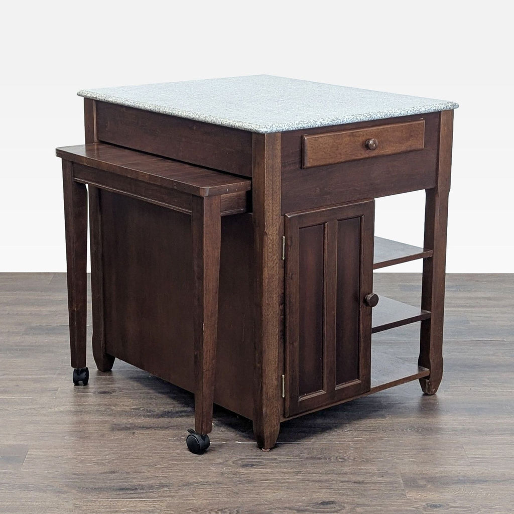 Versatile kitchen island with spacious cabinet, sturdy granite surface, and movable side table for added prep area.