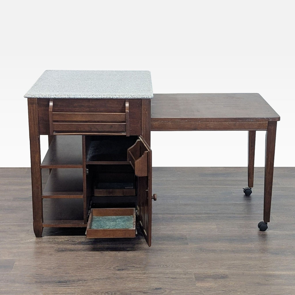 Granite-topped kitchen island featuring sliding drawers, multiple shelves, and a pull-out extension table.
