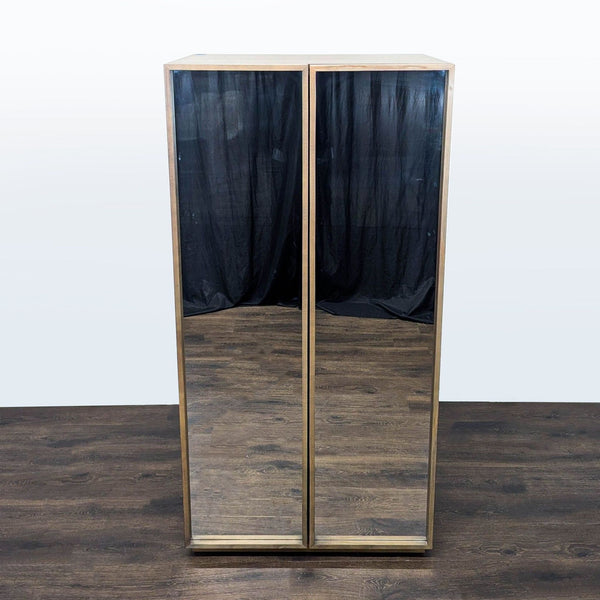 CB2 cabinet with hanging rod, shelves, and cubbies for organized storage in a modern design.