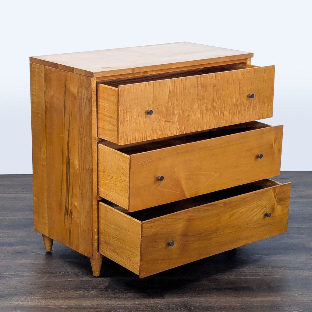 2. Solid wood dresser with clean lines, three drawers partially open, and simple metal knobs for easy access.