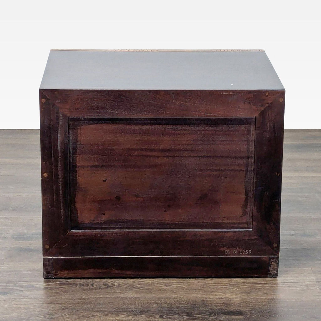 Reclaimed wood end table with patchwork drawer fronts, offering ample storage in a compact design.