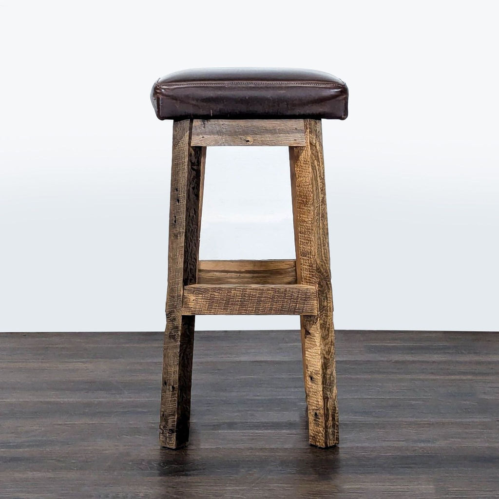 Handcrafted wooden stool with brown leather seat; Timeless Journey, farmhouse style.