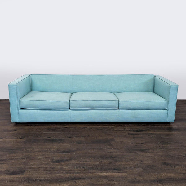 1. CB2 3-seat sofa in light blue fabric, modern design with clean lines, shown from the front on dark wood floor.  