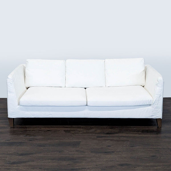 White Ikea 3-seat sofa with removable cover, wooden legs, and comfy cushions, gently used and modern.