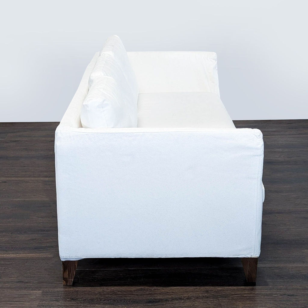 Ikea 3-seat sofa with sturdy wood legs and white cover, spacious, comfortable, and in good condition.