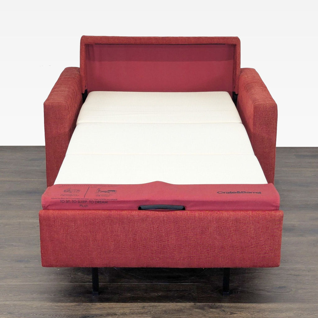 Stylish Crate & Barrel sleeper sofa in deep red, offering comfort and easy transformation into a guest bed.