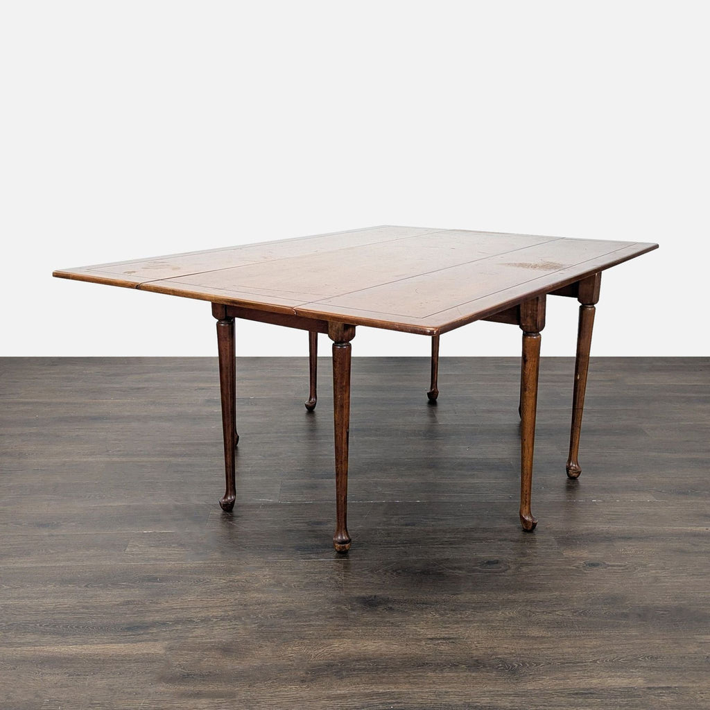 2. Sturdy rectangular wooden dining table with a classic, natural wood finish and turned legs.  