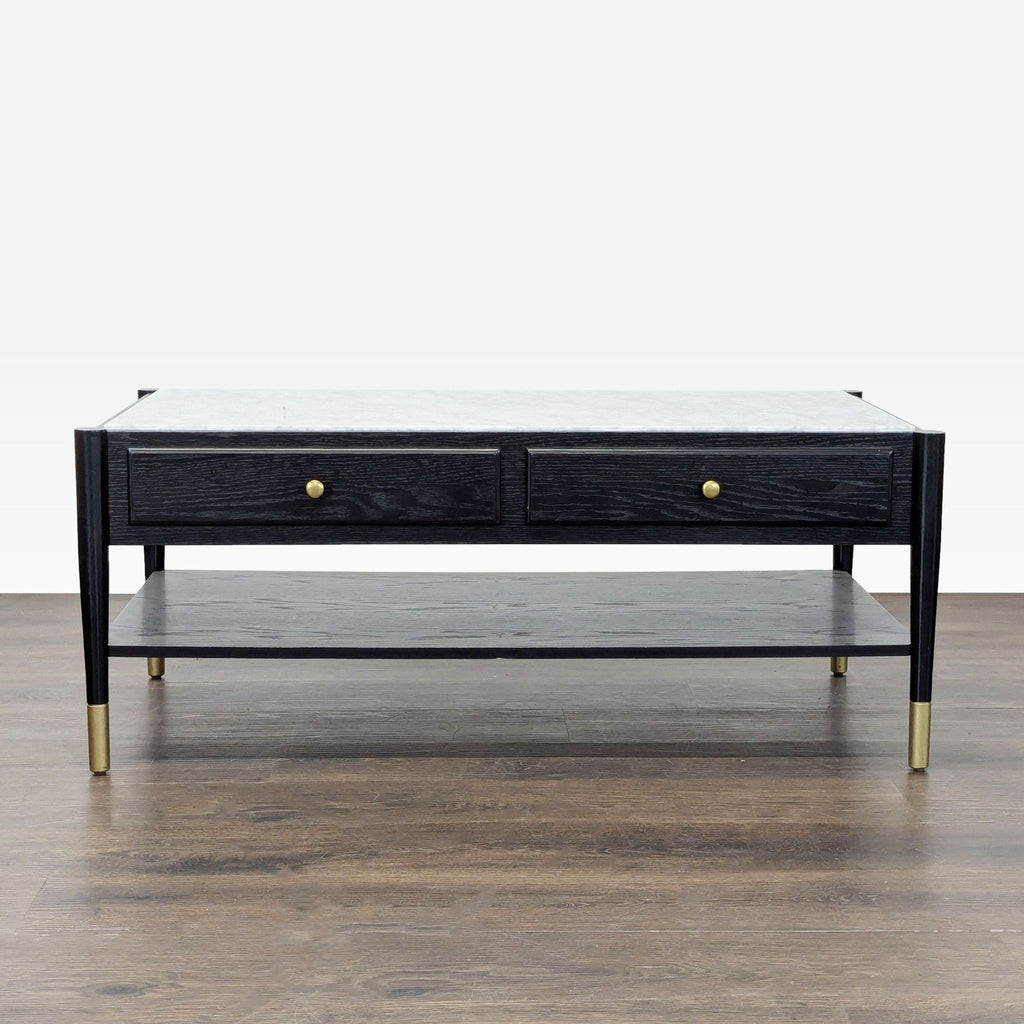 1. Black coffee table with gold accents, two front drawers, marble top, and a lower open storage shelf.