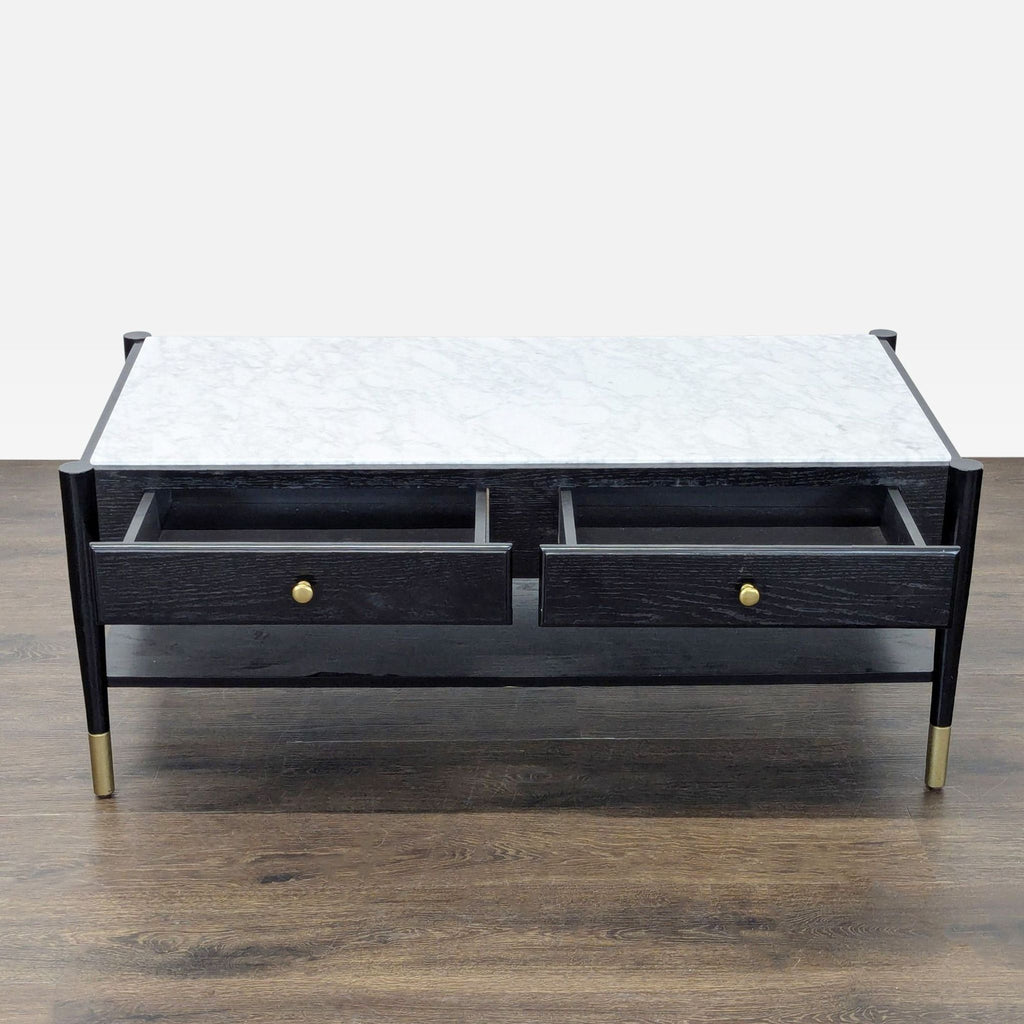 2. Coffee table with white marble top, black wood, two open front drawers, and a bottom shelf for storage.