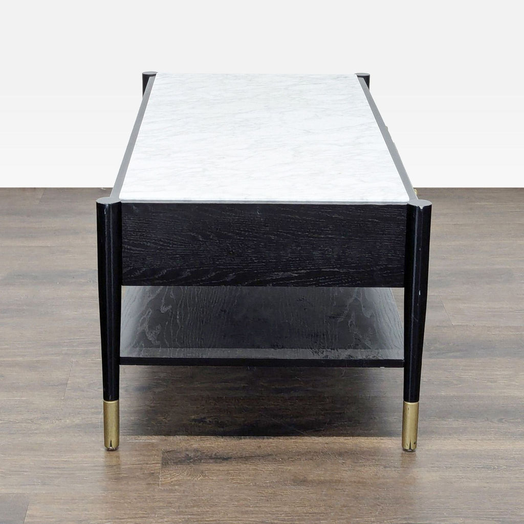3. Side view of a coffee table showing marble top, black wooden frame, open shelf beneath, and gold-capped legs.