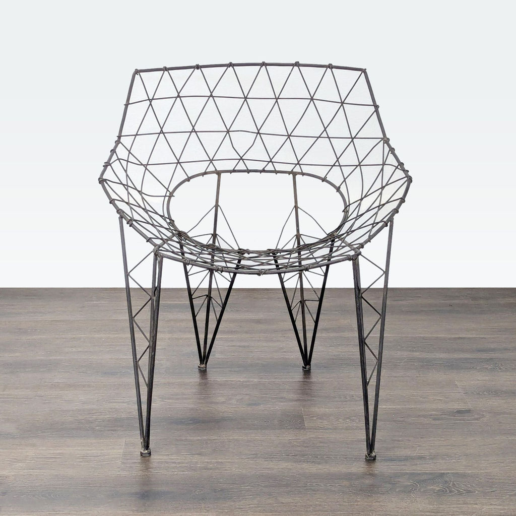 Modern chair with a geometric wireframe design and open structure, made from sturdy metal for a contemporary style.
