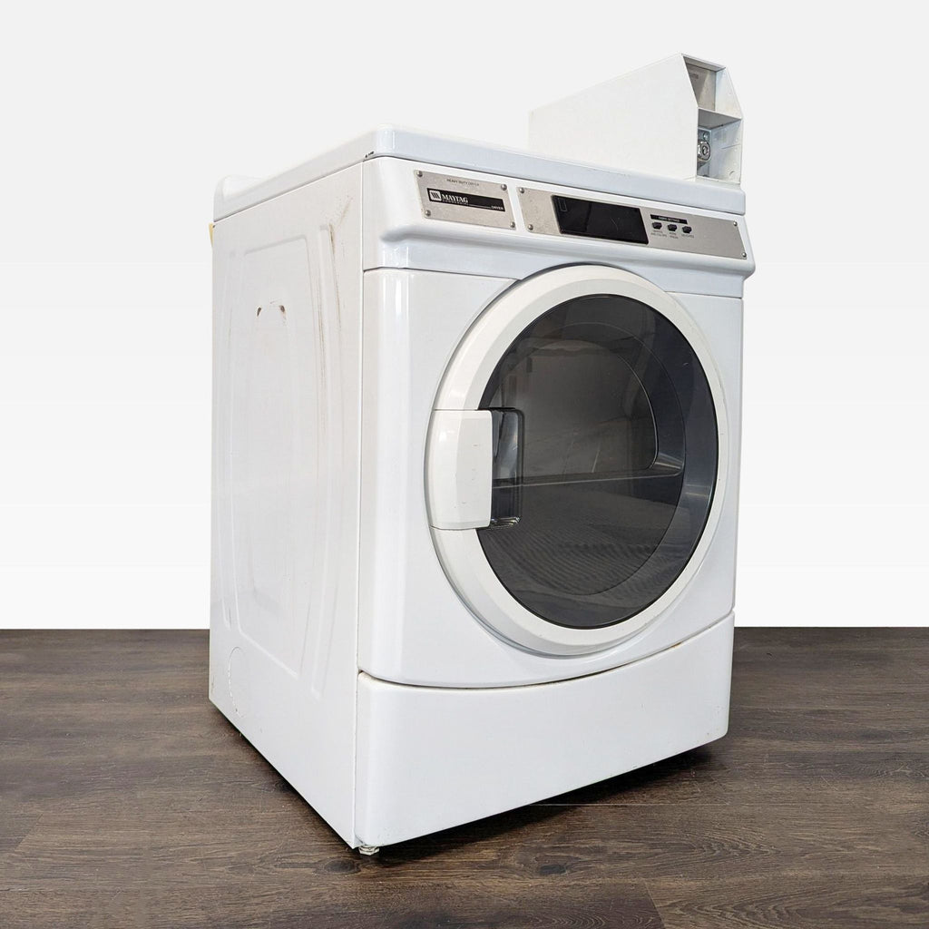 White Maytag front load dryer with robust build, user-friendly controls, and extra-large drum for commercial settings.