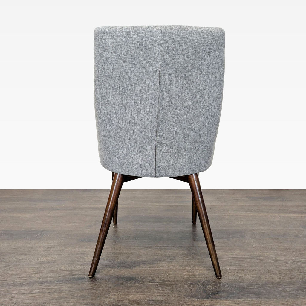 Cushioned seat mid-century chair featuring modern wood legs.