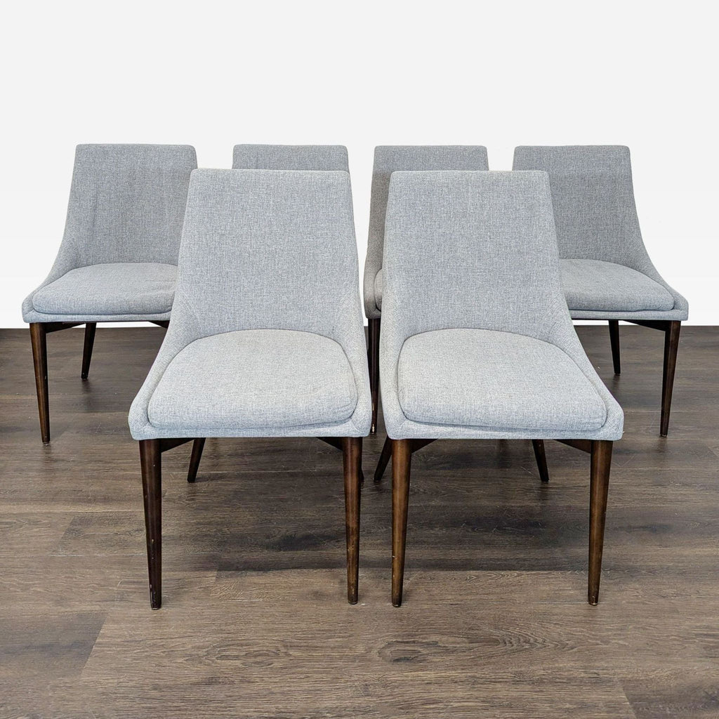 Mid-century chair with soft cushion and angled wooden legs.