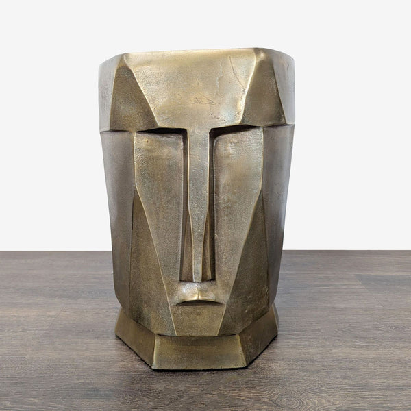 Bronze sculptural accent stool with geometric face design, ideal as a side table or artistic décor piece.