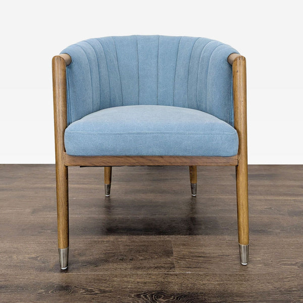 Modern Moe's lounge chair with light blue upholstery, vertical stitching, and wooden legs with metal tips.
