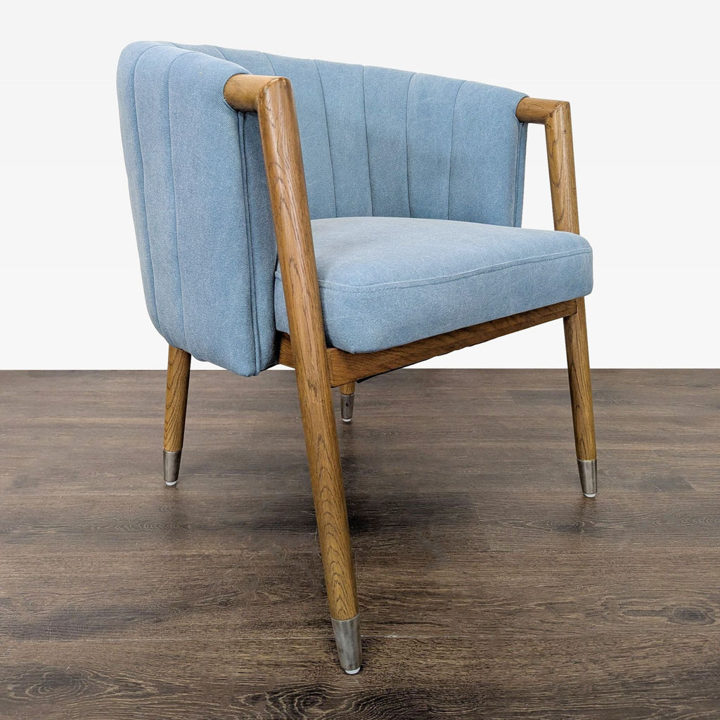 Stylish lounge chair by Moe's featuring blue fabric, vertical stitched back, and warm wood frame with metal details.