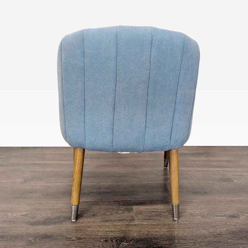 Contemporary Moe's lounge chair with upholstered blue seat, elegant stitching, and sturdy wood legs with modern accents.