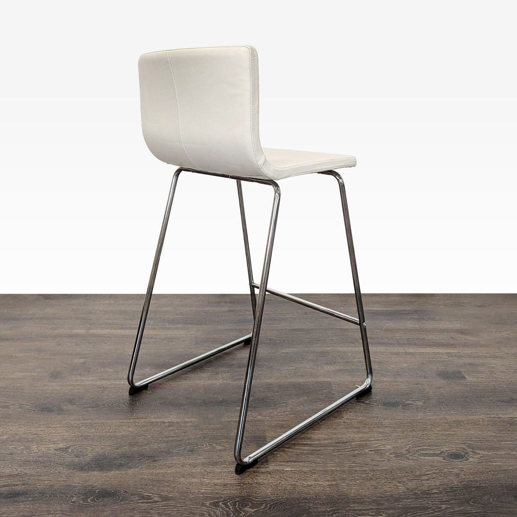 Modern Ikea ottoman featuring a chrome frame and cushioned leather seat by Ola Wihlborg.