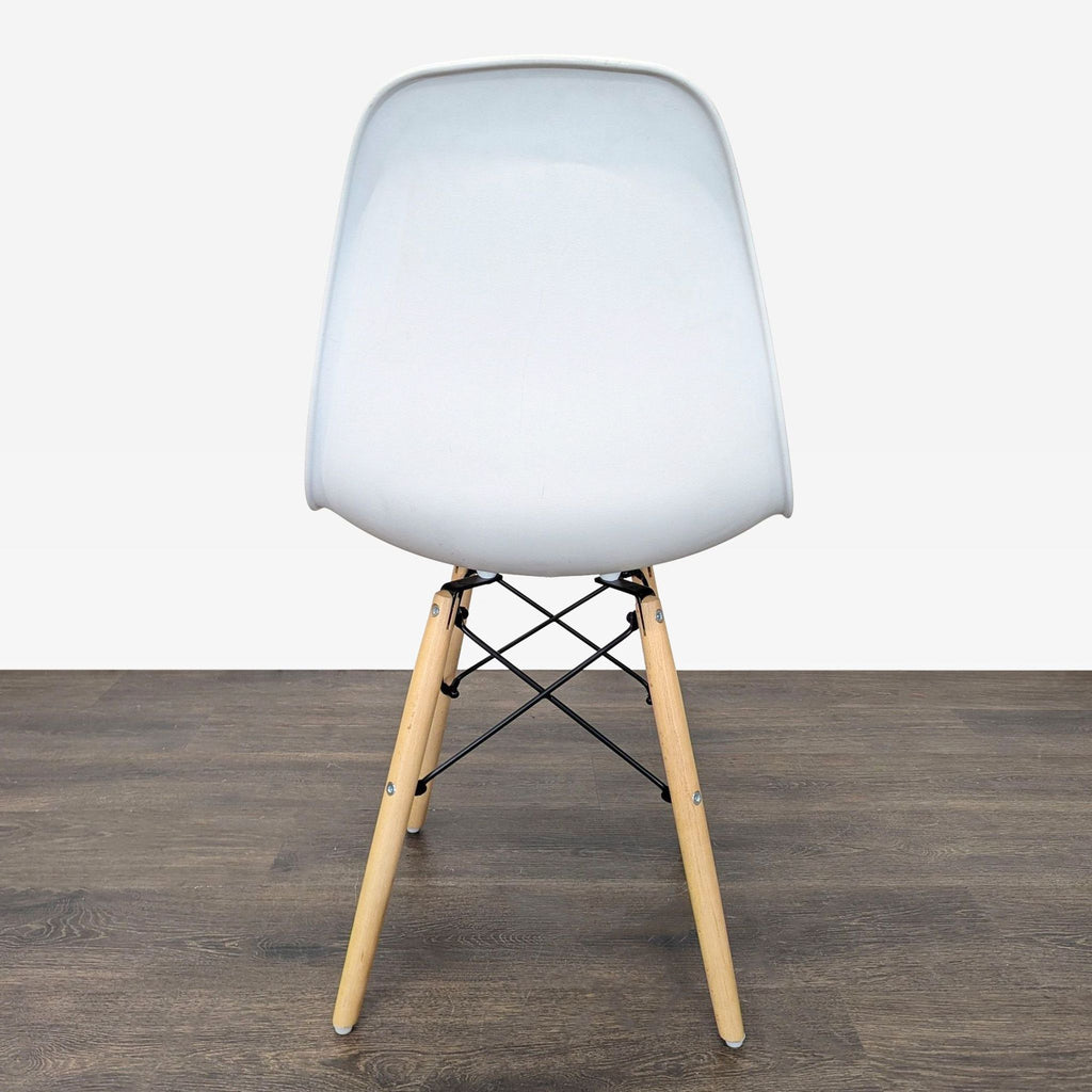 Pair of ergonomic dining chairs with white plastic seats, wooden legs, and a black chrome Eiffel-style base.  