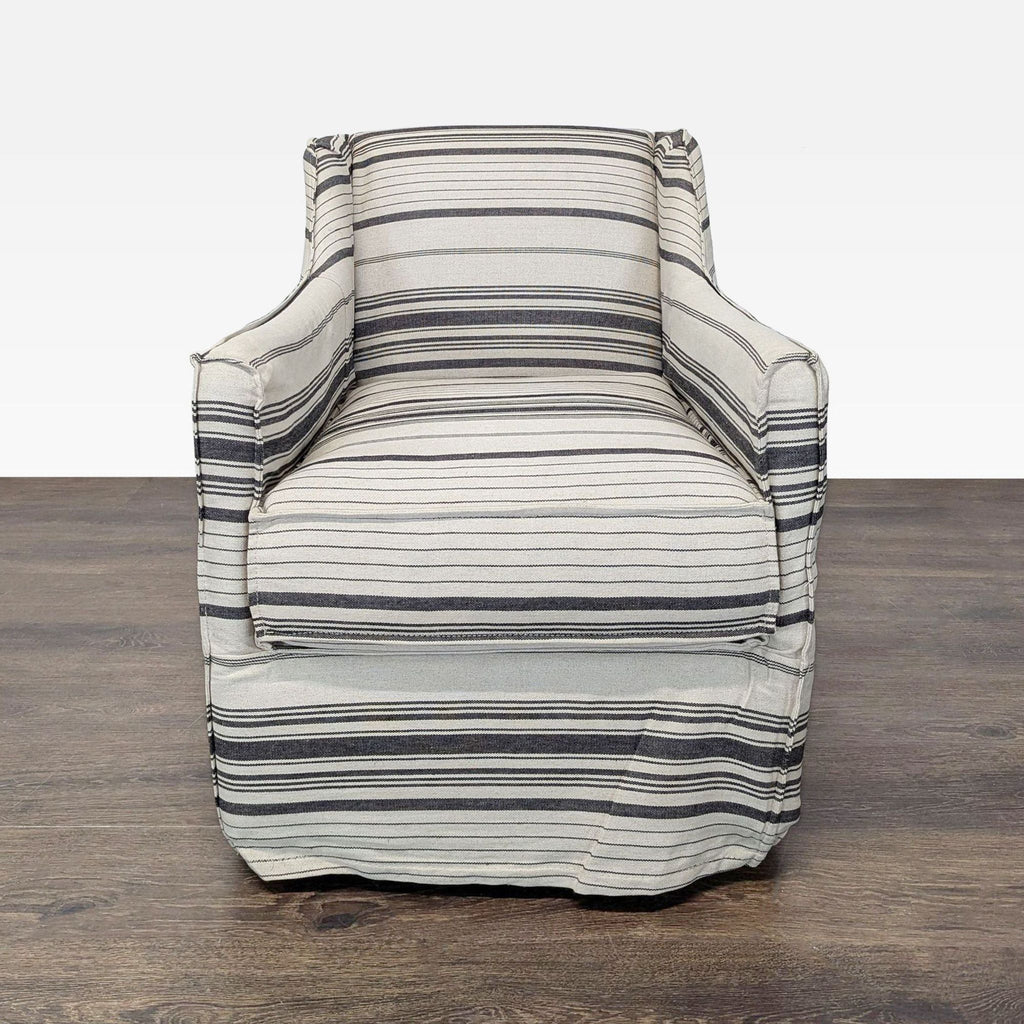 Striped gray and cream lounge armchair with skirted bottom and armrests, perfect for cozy living spaces.
