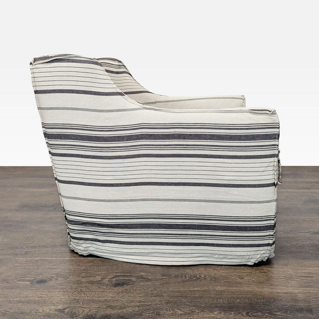 Comfortable lounge chair in neutral striped fabric, featuring a relaxed skirted design and supportive sides.