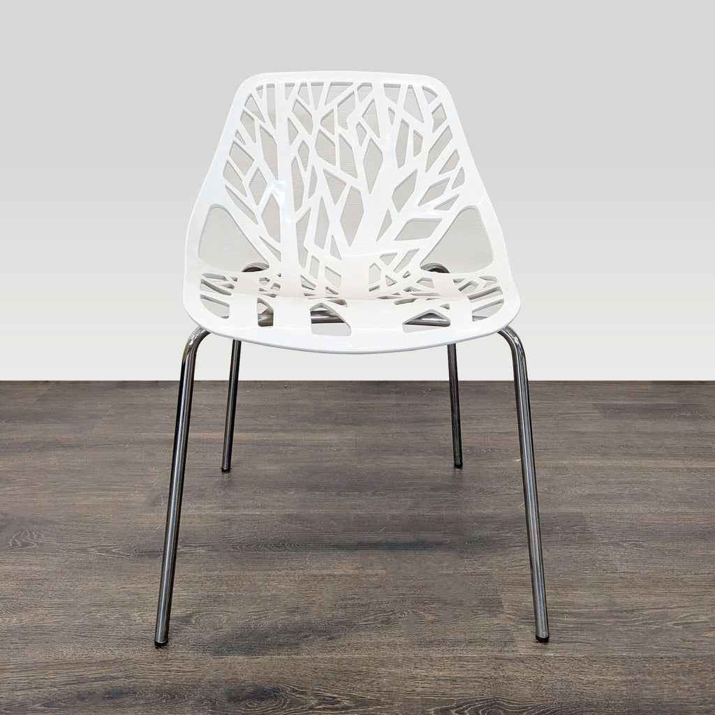 Four white chairs featuring unique tree-inspired cutouts on seat and back, lightweight and stackable for easy storage.